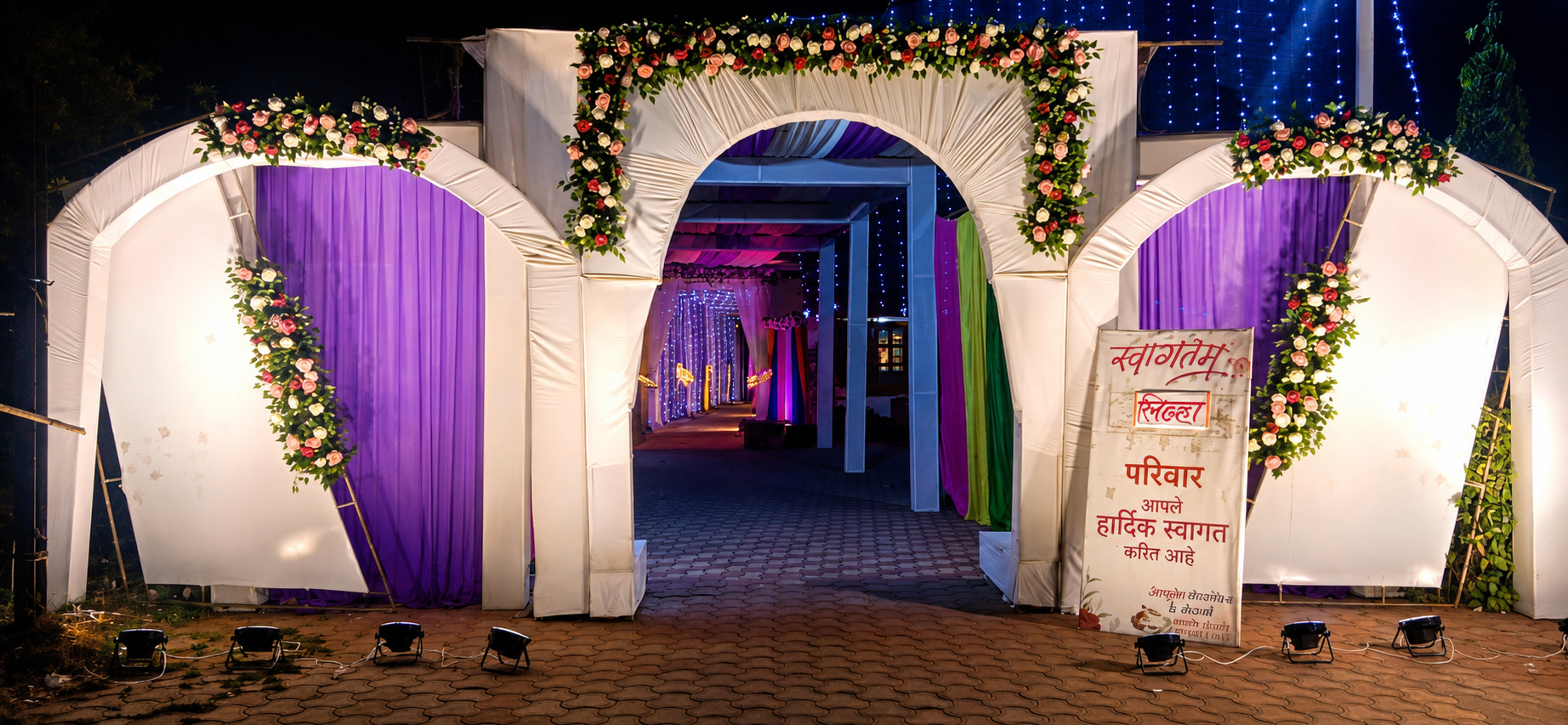 Festive Floral Wedding Entrance at Night